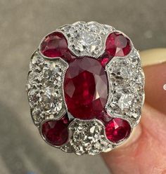 --Stone(s):-- (1) Natural Genuine Ruby (center)- Oval Cut - Milgrain Bezel Set - Vivid Red Color - Burma- 1.45ct (approx. based on the certification) ** See Certification Details Below For More Info ** (8) Natural Genuine Rubies - 4 Oval & 4 Square French Cut - Milgrain Bezel Set - Vivid Red Color - Burma - 1.10ctw (approx.) (28) Natural Genuine Diamonds - Old European Cut - Pave Set - 1.0ctw (approx.) Total Carat Weight: 3.55 (approx.) Material: Solid Platinum Weight: 6.26 Grams Ring Size: 7.0 Red Diamond Oval Cabochon Ring, Oval Multi-stone Ruby Jewelry, Elegant Oval Red Gemstones, Oval Ruby Gemstones For Wedding, Luxury Red Gemstones With Accent Stones, Classic Red Gemstones With Center Stone, Oval Multi-stone Ruby Ring, Oval Ruby Gemstones With Center Stone, Red Oval Art Deco Rings