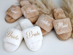 several pairs of slippers with bride and groom written on them