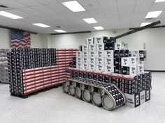 several stacks of beer cans stacked on top of each other in front of an american flag