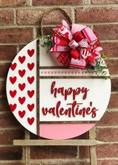 a sign that says happy valentine's day hanging on a brick wall