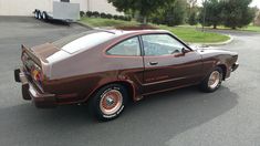 a brown car parked in a parking lot