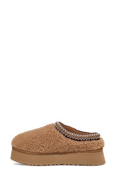 Exceptionally plush and indulgently comfortable, this fan-favorite slipper wrapped in thick curls of genuine shearling features a signature UGGbraid rope framing the collar and a platform sole made of lightweight sugarcane EVA. It's lined with cushy, warm UGGplush, a moisture-wicking textile made from a wool-rich blend but crafted to feel and wear like genuine shearling. Smoke Plume is a Nordstrom-exclusive color 2 1/4" platform (size 11) Genuine shearling and textile upper/UGGplush wool-blend l Ugg Sandals, Shearling Slippers, Ugg Tasman, Sheepskin Slippers, Leather Decor, Warm Boots, Ugg Slippers, Platform Slippers, Casual Slippers