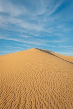 the sky is very blue and there are no clouds in the desert or sand dunes