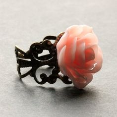 A pretty shade of peachy pink resin has been used to create a handmade resin rose that has then been set upon an adjustable filigree ring base in your choice of finish in this delicate rose ring that is made to be adjustable  from size 6 and up.Flower Size: 19mm To see this ring in all available colors, check here: http://etsy.me/1gr9dLcThe base for this handmade ring is adjustable, which makes this delicate rose ring comfortable no matter the size of the wearer's fingers (size 6 and up)  as wel Japanese Rose Ring, Adjustable Flower Shaped Rose Jewelry, Handmade Pink Flower-shaped Rings, Rose Petal Resin Ring, Pink Flower Ring, Vintage Rose-colored Flower-shaped Jewelry, Silver Buttons, Rose Ring, Peachy Pink