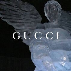 an angel statue with the word gucci in front of it's back side