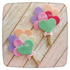 three heart shaped felt flowers with the words tough pick on them and tied to each other