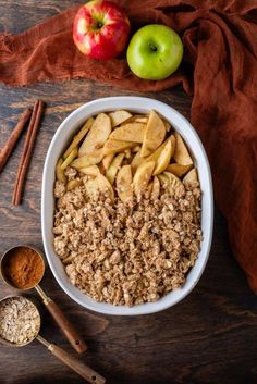 an apple and cinnamon crisp in a white bowl