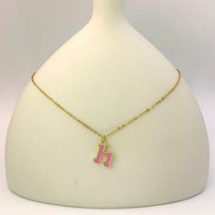 Add a touch of personality and whimsy to your look with our Personalized Pink Initial Necklace. This charming necklace features a custom letter of your choice, crafted with a gold-plated finish and filled with vibrant pink enamel. The delicate chain complements the playful letter, creating a cheerful and eye-catching piece. Perfect for everyday wear or as a gift, this necklace is a delightful way to express your unique style. Enamel Initial Pendant Necklace As Gift, Trendy Gold Charm Necklaces For Personalized Gift, Personalized Gold Enamel Charm Necklace, Pink Initial Pendant Jewelry For Mother's Day, Enamel Initial Pendant Jewelry Gift, Dainty Pink Charm Necklace With Adjustable Chain, Enamel Gold Jewelry With Initials, Trendy Pink Gold Plated Jewelry, Trendy Pink Gold-plated Jewelry