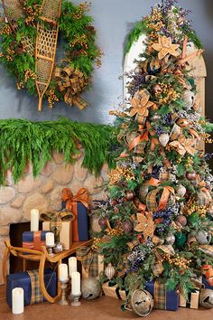 a decorated christmas tree sitting next to a fireplace