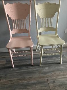 two wooden chairs painted in different colors and sizes, one pink and the other yellow