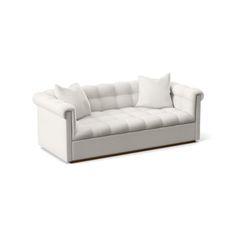 a white couch with two pillows on it