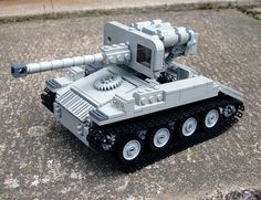 a toy tank is sitting on the ground