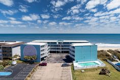 an aerial view of the ocean and buildings