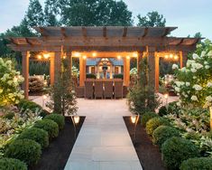 an outdoor dining area is lit up with lights