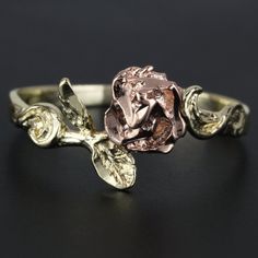 a rose ring is shown on a black surface