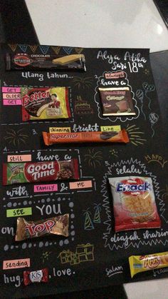 an assortment of snacks on a chalkboard with writing and magnets attached to it