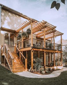 a large wooden house sitting on top of a lush green field