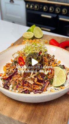 a white bowl filled with vegetables on top of a wooden cutting board