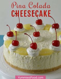 there is a cake with pineapples and cherries on the top that says pina colada cheesecake