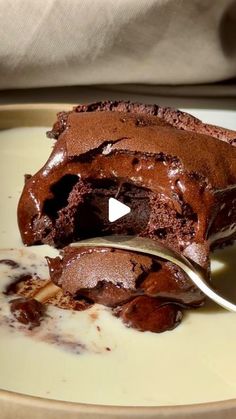 a piece of chocolate cake is being eaten with a fork