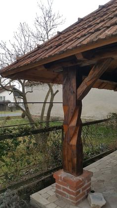 a wooden structure sitting on top of a brick walkway