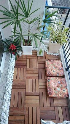 a balcony with plants and rocks on the floor