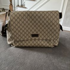 a purse sitting on top of a carpeted floor