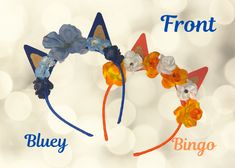 the blue and orange cat ears have flowers on them, along with words from front to back