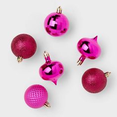 pink ornaments are arranged on a white surface