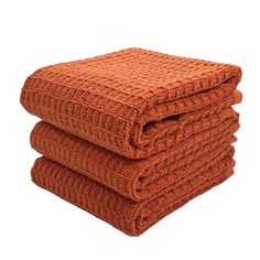 four orange towels stacked on top of each other