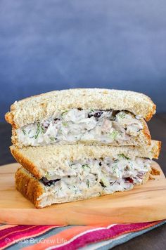 a sandwich cut in half sitting on top of a cutting board