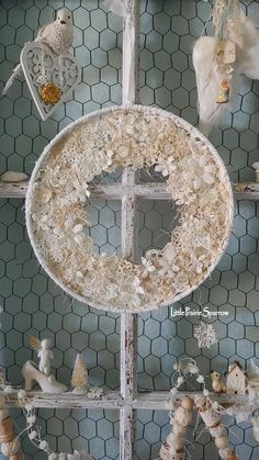 an old window is decorated with wreaths and figurines