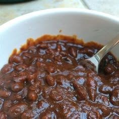 a white bowl filled with beans on top of a table