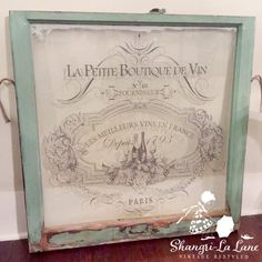 an old framed sign with french writing on it's side and the words la petite boutique de vin