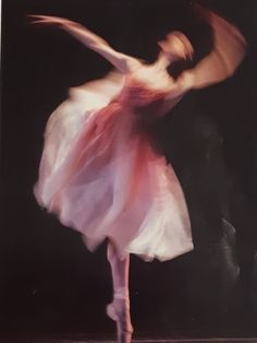 a woman in a white dress is dancing