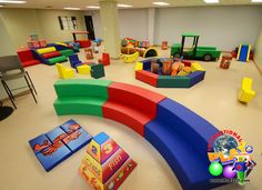 children's play area with soft foam blocks, toys and games on the floor