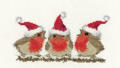 three little birds with santa hats on their heads are standing in front of each other