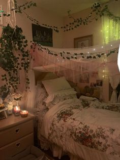 a bedroom with an unmade bed and lots of greenery hanging from the ceiling