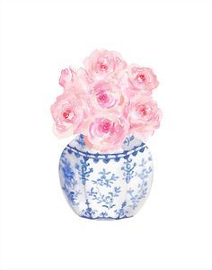 a blue and white vase with pink roses in it