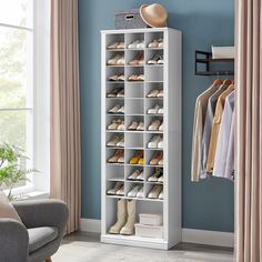 a white shoe rack with several pairs of shoes on it in front of a blue wall