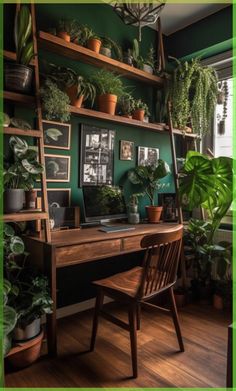 a wooden desk topped with lots of plants and greenery next to a green wall