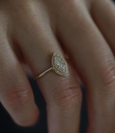 a woman's hand with a diamond ring on it