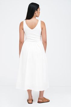 You're the focus in our Emmy Dress, a timeless staple that embodies the beauty of minimalism. Her sleeveless, European ponte bodice features a V-neck mirrored by a V-shaped waistline, leading to a softly gathered skirt from 100% European poplin cotton with a poplin cotton lining. Finished with a side zip and pockets, Emmy is designed to make your presence felt in any setting. Also available in black. | Shannon is 5'8 (173 cm) tall, wearing size M. Total length is approximately 47" (119.5 cm).Top White Sleeveless Stretch Midi Dress, Sleeveless Summer Dresses With Minimal Stretch, White V-neck Elastane Dress, Chic Spring Dresses With Minimal Stretch, Elegant Elastane Dresses For Daywear, Gathered Skirt, The Grace, Cotton Voile, On Off