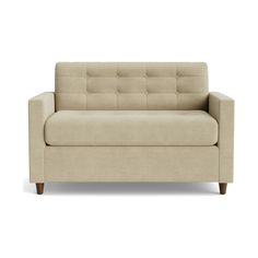 a beige couch sitting on top of a white floor