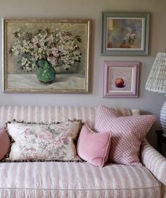 a living room filled with furniture and pictures on the wall above it's couch