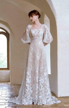 a woman in a white dress standing on a tile floor