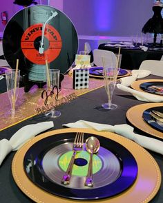 the table is set up for an event with place settings and silverware on it