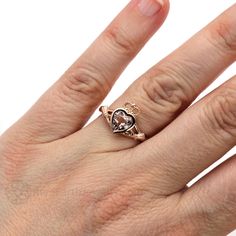 "A symbol of love, friendship and loyalty dating back to the 17th century, the Claddagh ring is a beloved tradition in Ireland. It's been re-created here in this updated contemporary celtic design, with a beautiful natural peachy pink Morganite at the heart. It's available in your choice of 14K or 18K White, Yellow or Rose Gold or Platinum. Made to order. Please allow four to six weeks for delivery. Inquire for the matching wedding band. ABOUT THIS RING Shown on Ring Size 7 Hand Engagement Shank Antique Sterling Silver Promise Jewelry, Antique Sterling Silver Jewelry For Promises, Symbolic Rose Gold Wedding Jewelry, Heirloom 14k Gold Heart Promise Ring, Symbolic Rose Gold Promise Rings, Heirloom Style Valentine's Day Jewelry Ring, Valentine's Day Heirloom Ring Jewelry, Valentine's Day Heirloom Ring, 14k Rose Gold Promise Ring Jewelry