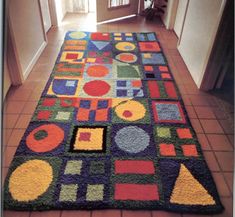 a multicolored rug on the floor in a hallway