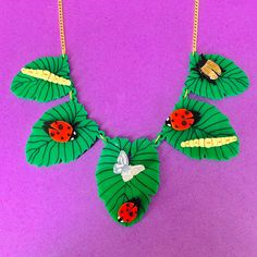 Bug 🐛 necklaces is a fun quirky piece. It's a statement piece that will look great with any outfit.  The necklace is made with green Perspex leaves. layered on top are bugs, some have been hand heated and moulded. These are linked to a curb chain using jump rings.  Do not get wet as this may cause the detail to fade. If you have any questions drop us a line!💌 We are more than happy to help! 😁 To clean your necklace you can simply wipe with a glasses cloth or soft cloth to remove finger marks. Acrylic is a fragile material so please store in a jewellery box to prevent damage.  As ever for safety please keep away from small children. Handmade Novelty Plastic Jewelry, Playful Green Plastic Jewelry, Green Resin Necklaces For Jewelry Making, Trendy Handmade Resin Necklace, Green Fun Plastic Jewelry, Fun Green Plastic Jewelry, Green Plastic Jewelry For Gifts, Quirky Handmade Green Jewelry, Unique Green Resin Necklaces